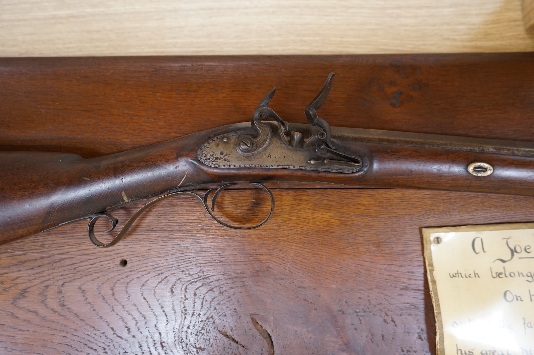 A single barrel flintlock sporting gun by Manton, half stocked, with signed lock and rainproof pan, platinum lined vent, and iron furniture (worn smooth)